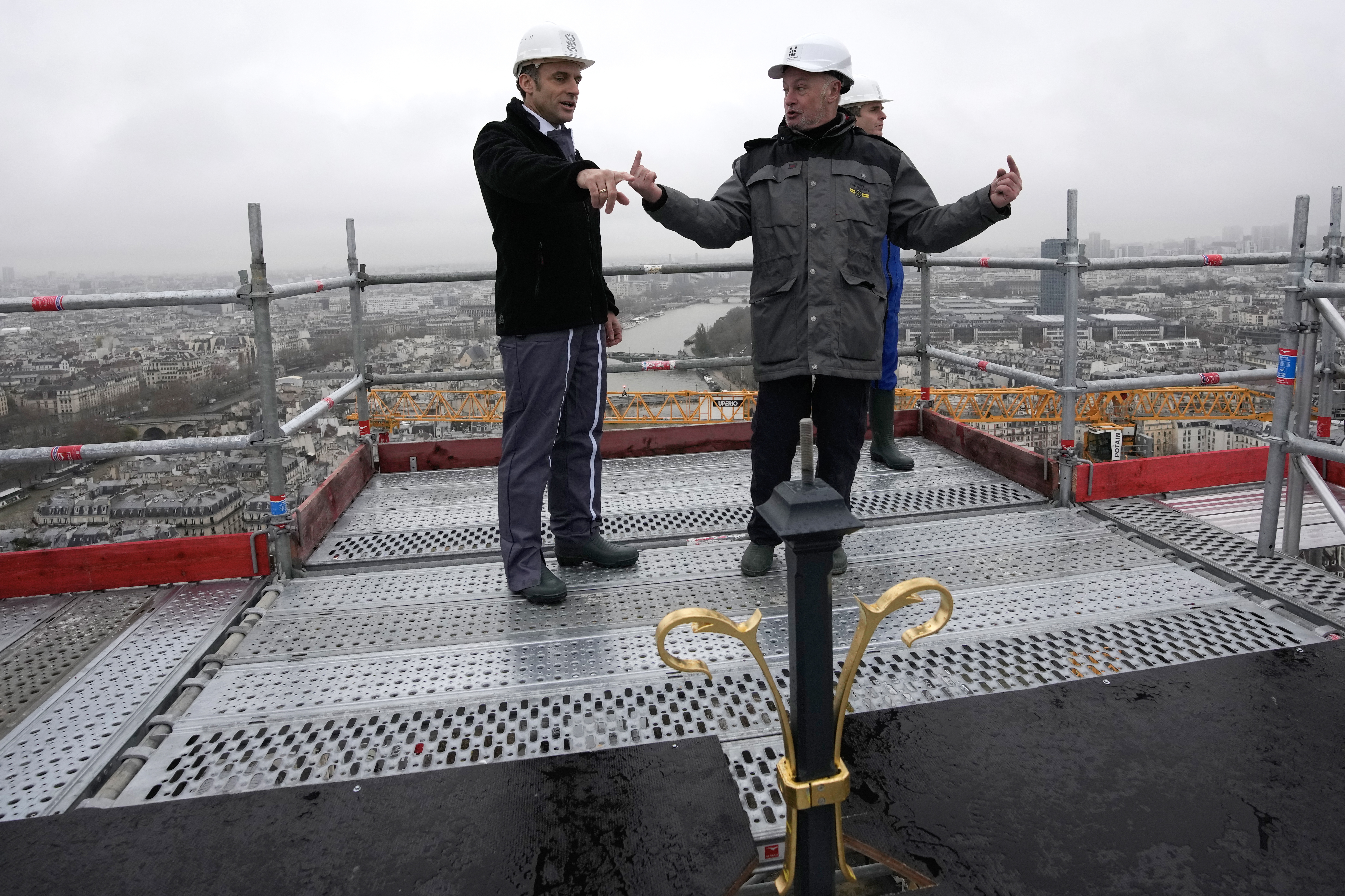 French President Emmanuel Macron on top of Notre Dame, reviewing the restoration work